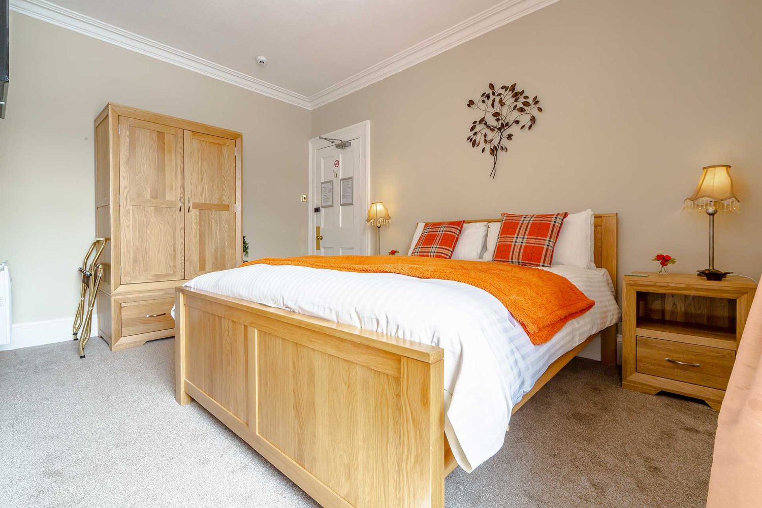 Large double bed in lightly decorated room